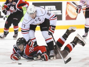 Owen Sound captain Zach Nastasiuk stands over the Niagara IceDogs' Aaron Haydon in the Attack's 6-2 win on Saturday in Ontario Hockey League action.