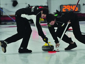 Brett Moxham and Devin Wiebe of the Austin Mustard rink sweep during action at the Canola Junior Provincials in Portage la Prairie Dec. 29. (Kevin Hirschfield/THE GRAPHIC/QMI AGENCY)
