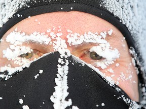 Doug Pollard is covered in frost as he returns from a jog in a -42 wind chill on Oak Street. The cold snap has caused December to be the busiest CAA Manitoba has seen in at least eight years. (Brian Donogh/Winnipeg Sun)