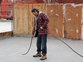 Sarnia's Bill Rose preps for his daily ritual of putting water on the backyard rink he's built at his Isabella Street home. Rose has been making the rink for three years now, and says there is a definite science to backyard rink making. SHAUN BISSON/THE OBSERVER/QMI AGENCY