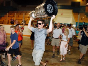 Belleville, Ont. native and winger for the Chicago Blackhawks Andrew Shaw hoists the Stanley Cup hight as he is welcomed and cheered by hundreds of hockey fans at Memorial Arena in Belleville, Ont. Thursday, July 18, 2013. JEROME LESSARD/The Intelligencer/QMI Agency