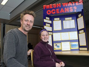 Mark Read, who will be a mentor in the upcoming Helping Saturdays to prepare students for the Kingston Frontenac Lennox and Addington Science Fair, joined Brenna Lamoureux to look over her entry from last year. (Michael Lea The Whig-Standard)