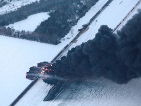 Smoke rises from scene of a derailed train near Casselton, North Dakota December 30, 2013. REUTERS/Michael Vosburg/Forum News Service