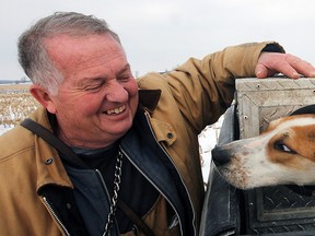 Oxford Centre coyote-hunting gang member Robert Hird with a pair of his Walker Foxhound/July crosses. Jeff Tribe/Tillsonburg News