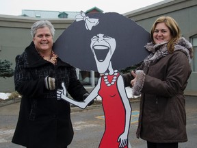Barbara Revelle (left), Gilda's Club Southeastern Ontario acting executive director, with Carolyn Proderick, a director on the clubs board, and a cutout Gilda outside the clubs future home at 55 Rideau St.