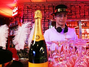 Tom Silvera, a DJ at MJ's Nightclub, helps staff at the Bell Boulevard bar gear up for New Year's Eve festivities. Partygoers bringing in 2014 at MJ's will be treated to giveaways such as iPods. 
JASON MILLER/The Intelligencer