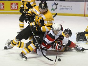 Kingston's Sam Bennett (93) and Ottawa's Sam Studnicka chase the puck in front of Kingston's MIchael Moffat during the first period of Wednesday afternoon's 6-5 shootout win by the Frontenacs at the Rogers K-Rock Centre. (Elliot Ferguson/The Whig-Standard)