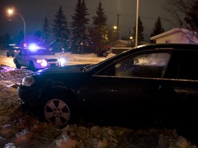 FILE: A crashed car is seen as an Edmonton Police Service cruiser responds to slippery roads due to freezing rain in Edmonton, Alta., on Saturday, Dec. 14, 2013. The vehicle was involved in a two-car crash. Ian Kucerak/Edmonton Sun