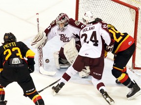 Peterborough Petes' goalie Andrew D'Agostini makes a save against Belleville Bulls' Niki Petti during the Petes' 5-1 win Wednesday at the Yardmen Arena. Jason Miller The Intelligencer