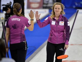 Skip Chelsea Carey (right) high-fives second Kristen Foster after making a shot at the Roar of the Rings last month. Carey is the top seed for next week's provincial Scotties tournament in Virden. (FRED GREENSLADE/REUTERS FILE PHOTO)