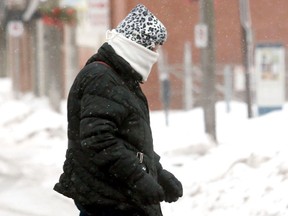 A pedestrian is bundled up against blowing snow and frigid temperatures while they walk in downtown Belleville, Thursday. Temperatures reached minus 18 degrees but felt more like minus 33 with the wind chill, according to Environment Canada. 
EMILY MOUNTNEY/THE INTELLIGENCER