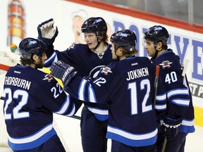 Jacob Trouba celebrates his goal with teammates during the second period against  Buffalo on Tuesday night. The Jets need to sign budding stars like Trouba and Mark Scheifele to long-term contracts before they realize nobody wants to play in Winnipeg, suggests TSN analyst Jeff O'Neill. (Bruce Fedyck/USA TODAY Sports)