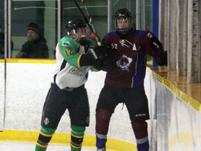 Petrolia Oilers forward Ryan Atkinson (in white) hits Amherstburg Stars defender Dean Patterson in the first period of their game in the Petrolia Regional Silverstick Finals on Thursday, Jan 2. Patterson scored the game winning goal in a 3-0 Stars victory. SHAUN BISSON/THE OBSERVER/QMI AGENCY