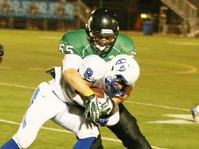 Mark Korte (65), who will be attending the University of Alberta in the coming school year and play football for the Golden Bears, makes a tackle while playing for his Spruce Grove Panthers high school team in 2013. Korte is one of four Panthers who have already accepted scholarships to play football for the Golden Bears next season. - Gord Montgomery, File Photo