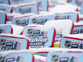 Snow sits on seat cushions before fans are let into the NHL Winter Classic hockey game between the Maple Leafs and Detroit Red Wings at Michigan Stadium in Ann Arbor, Michigan on Wednesday January 1, 2014. (CRAIG GLOVER/QMI Agency)