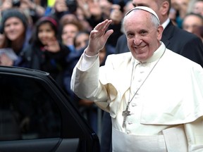 Pope Francis waves as he leaves at the end of his mass at the Church of the Most Holy Name of Jesus in downtown Rome January 3, 2014. 
(REUTERS/Alessandro Bianchi)