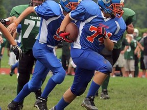 Two Sarnia football players, John Day and Maximillian Michelluci, were recently invited to represent Team Ontario at the Football University All-American Games. Pictured above is Michelluci, a defensive tackle, carrying the football downfield in SMAA action. SUBMITTED PHOTO