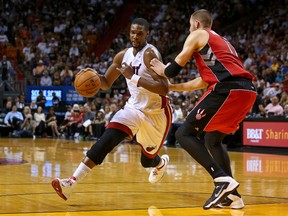 Heat’s Chris Bosh drives to the hoop on the Raptors’ Jonas Valanciunas in Miami last night. (Getty)