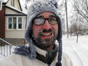 Daniel Gagnier, of St. Thomas, wears his winter face as he snowblowed neighbours along his block Monday morning on Moore St. "It's all right," he said of the wintry weather. "It's Canada!"