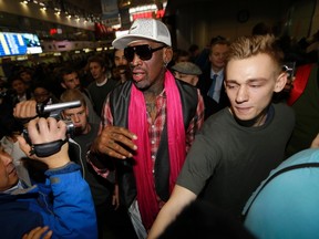 Former NBA player Dennis Rodman is surrounded by journalists as he arrives at the Beijing Capital International Airport to leave for Pyongyang, North Korea on Monday, Jan. 6, 2014. (Jason Lee/Reuters)