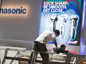 Workers build a display at the Panasonic booth in preparation for the 2014 Consumer Electronics Show (CES) at the Las Vegas Convention Center in Las Vegas, Jan. 4, 2014. REUTERS/Steve Marcus