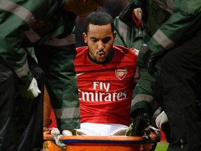 Arsenal's Theo Walcott is stretchered off the pitch during their English FA Cup soccer match against Tottenham Hotspur at the Emirates stadium in London, January 4, 2014.  (REUTERS)