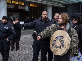 Protesters who managed to sneak on stage with Harper to oppose his climate change policies say they got into the event by wearing black clothes and aprons.

Carmine Marinelli/QMI Agency