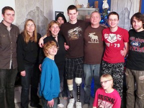Mitchell resident Adam Knox (centre), was involved in a serious train accident on Boxing Day 2012 and returned home for a surprise visit this Christmas. Gathered together for the visit are family members from left: Andrew Knox, Tia Conley, Pauline Harrison, Sydney Conley, Adam Knox, Phil Knox, Aaron Knox, Michael Laframboise. In front is Chesley Harrison-Knox and Tiarelle Cockerill. SUBMITTED PHOTO