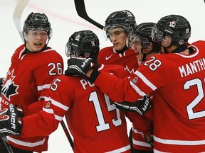 Canada's Curtis Lazar (L) celebrates his goal against Slovakia with teammates Derrick Pouliot (15) Jonathan Drouin (C), Nic Petan and Anthony Mantha during the first period of their IIHF World Junior Championship ice hockey game in Malmo, Sweden, December 30, 2013.  (REUTERS)