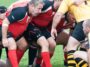 Former longtime Intelligencer reporter and city editor, Chris Malette (left), gets set to bang heads against Cobourg rivals during a Belleville Bulldogs Old Boys rugby match at MAS Park. (DON CARR for The Intelligencer)