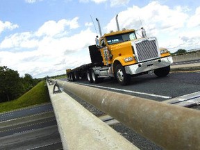 A truck travels over the Veterans Memorial Parkway overpass at Hwy. 401. Council on Monday endorsed a plan to build a $500,000 wooden fence as a traffic noise barrier for frustrated neighbours. (Free Press file)