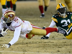 Niners wide receiver Michael Crabtree (left) makes a diving catch during second-half action Sunday night in Green Bay. (USA TODAY SPORTS)
