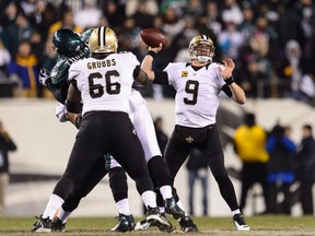 Saints quarterback Drew Brees (right) passes for a completion Saturday night in a win against the Eagles in Philadelphia. (USA TODAY SPORTS)