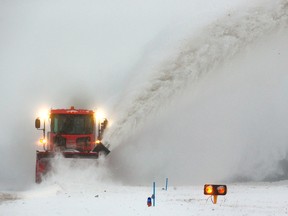 Jim Forbes runs a massive snowblower at London International Airport, throwing snow about 30 metres as he clears a taxiway to keep it clear for aircraft in London Monday. (Mike Hensen / The London Free Press)