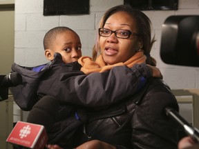 Angelo Epassa was returned to his parents after going missing Monday. He's pictured with his mom, Nathalie. (JACK BOLAND, Toronto Sun)