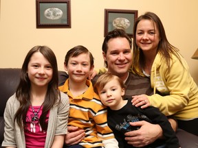 Gino Donato/The Sudbury Star
Rosalyn Steen, right, with her husband Dawson and kids Taylor Keith, 11, Leland Keith, 8, and Noah Steen, 3 ,on the couch from their temporary home in Skead. The family has been displaced from their home due to a fire on December 18.