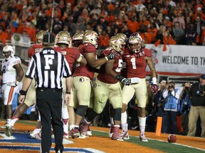 Florida State Seminoles wide receiver Kelvin Benjamin celebrates his winning touchdown catch with teammates against the Auburn Tigers during the second half of the 2014 BCS National Championship game at the Rose Bowl.  (Matthew Emmons-USA TODAY)