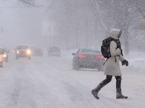 Vehicles and pedestrians make their way through the snow on Ontario St. in Stratford, Ont., on January 6, 2014. (Scott Wishart/QMI Agency)