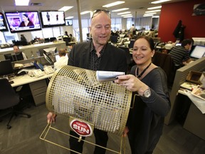 The Toronto Sun's Mike Strobel and Christina Fleming draw names for the Variety Village fundraiser winners on Monday, January 6, 2014, in the Sun's King St. E. newsroom. (Michael Peake/Toronto Sun)
