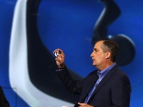 Intel CEO Brian Krzanich displays the Intel smart headset and earbud designs, providing full stereo audio, heart rate monitor and pulse check, during his keynote address at the annual Consumer Electronics Show (CES) in Las Vegas, Jan. 6, 2014. REUTERS/Robert Galbraith