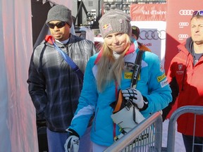 U.S. skier Lindsey Vonn, seen here with boyfriend Tiger Woods, announced she will not be able to participate at the Sochi Winter Olympics. (Robert Pratta/Reuters)
