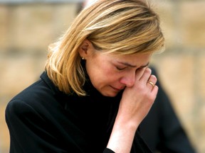 Spain's Infanta Cristina wipes her tears as she leaves Madrid's Almudena cathedral after attending the state funeral for the 190 victims of the Madrid train bombings, in this March 24, 2004 file photo. (REUTERS/Sergio Perez/Files)