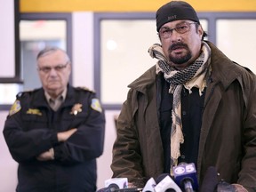 Maricopa County Sheriff Joe Arpaio, left, watches as actor and Maricopa County posse member Steven Seagal addresses the media about a simulated school shooting in Fountain Hills, Ariz., on February 9, 2013. (REUTERS/Darryl Webb)