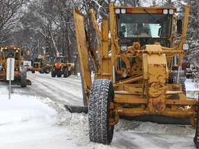 Graders and plows clear snow on Grosvenor Avenue near Guelph Street earlier this winter. The city confirmed Tuesday that crews missed an entire neighbourhood. (Kevin King/Winnipeg Sun file photo)