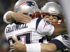 New England Patriots quarterback Tom Brady (R) hugs Patriots receiver Reche Caldwell in this 2006 file photo. (REUTERS )