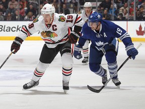 Jonathan Toews breaks past Joffrey Lupul during an NHL game last month. Toews, a Winnipegger, was named to Canada's Olympic team on Tuesday. (Claus Andersen/Getty Images/AFP)