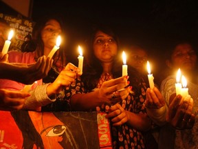 Women hold candles during a special prayer ceremony to pay homage to a Delhi gang-rape victim, in the western Indian city of Ahmedabad in this December 14, 2013 file photo. (REUTERS/Amit Dave)