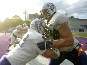 Brendan Dunn, right, shown in this image during his days as a lineman at Western university. (File photo)