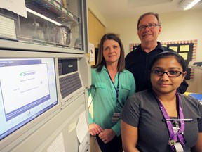 Tillsonburg District Memorial Hospital is upgrading patient safety and care with the implementation of the Healthcare UnderGoing Optimization (HUGO) program. HUGO utilizes electronic technology for ordering tests, prescribing medication and adding barcoding, a shift from a paper process in order to help ensure the right patient is receiving the right medication at the right time. Pictured here, with an Omnicell automated dispensing cabinet, are: from left to right, are: Pharmacy Tech Christine Bailey, Pharmacy Services Coordinator Brian Fathers, and RN Mariya Pops. Jeff Tribe/Tillsonburg News