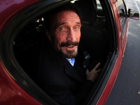 Software pioneer John McAfee is escorted by immigration officers to the Guatemalan Airport in Guatemala City in this Dec. 12, 2012, file photo.years. REUTERS/Jorge Dan Lopez/Files